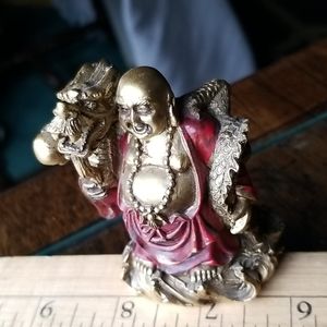 3 inch gold resin Buda holding a dragon.